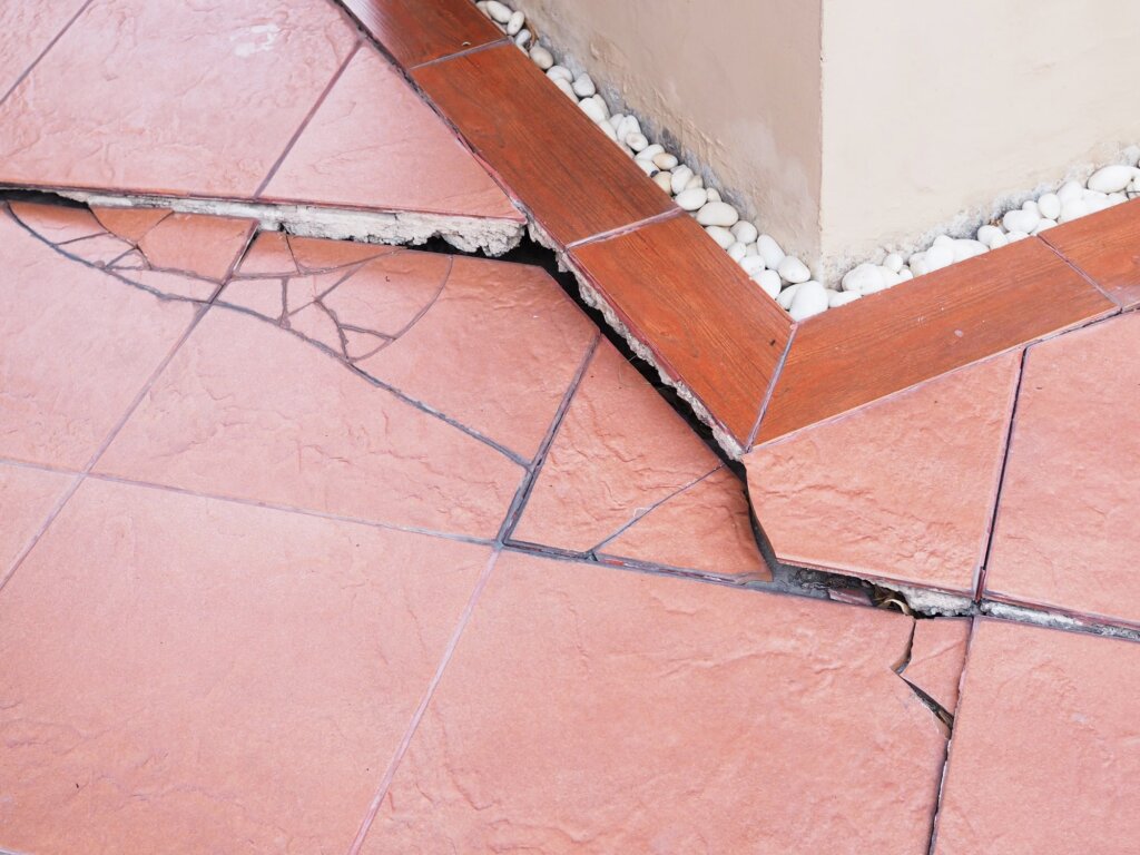 cracked tile of home showing sinking foundation