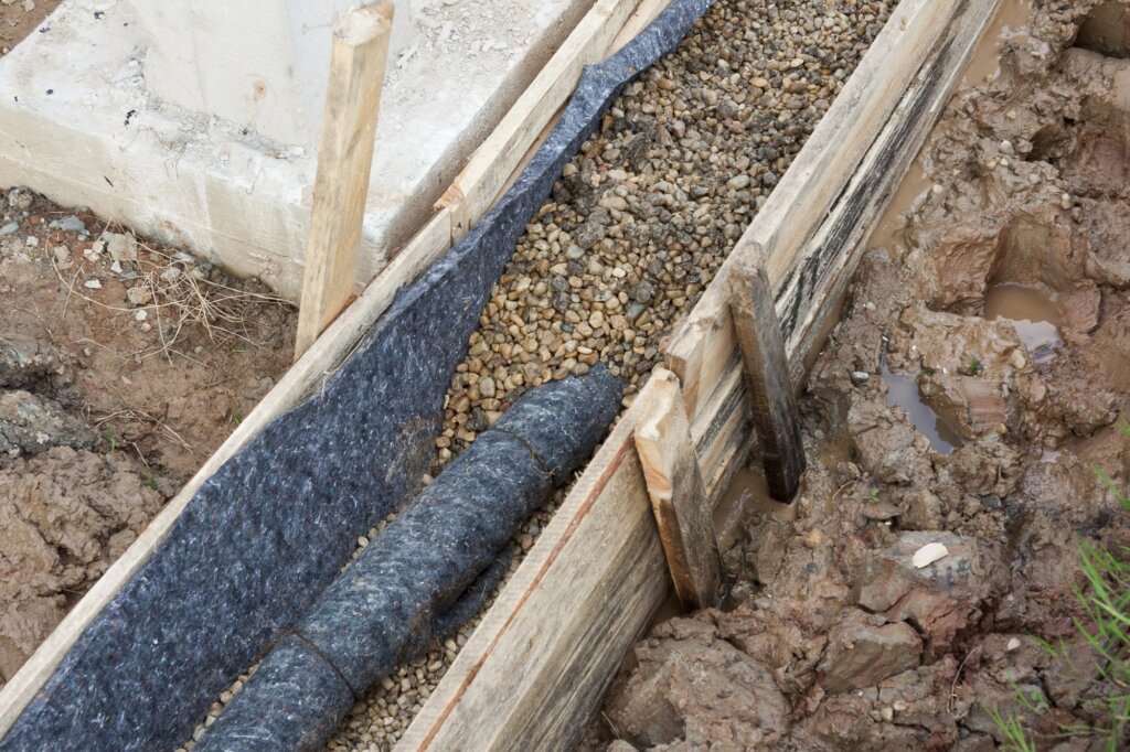 foundation drainage halfway filled with soil