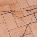 Cracked tile floor caused by foundation settlement and movement