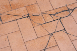 Cracked tile floor caused by foundation settlement and movement