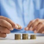 man counting coins thinking of how to pay for foundation repair