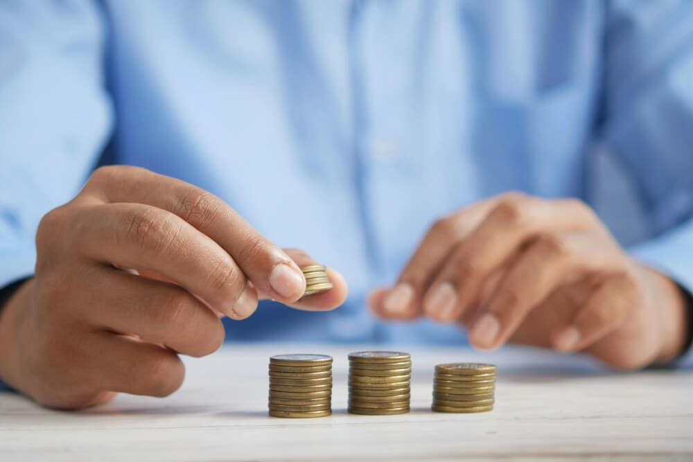 man counting coins thinking of how to pay for foundation repair