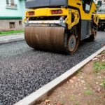 Asphalt roller compacting a driveway surface during repair