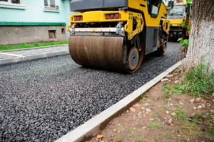 Asphalt roller compacting a driveway surface during repair
