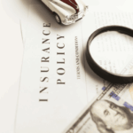 Insurance policy documents and magnifying glass representing homeowners insurance and foundation repair coverage questions