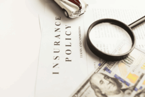 Insurance policy documents and magnifying glass representing homeowners insurance and foundation repair coverage questions