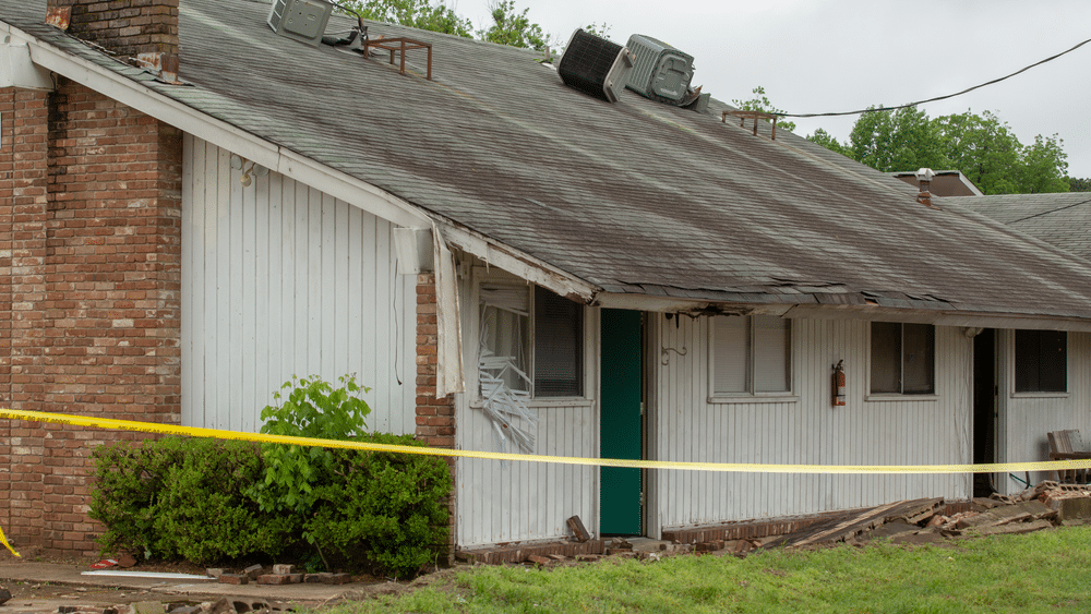 Damaged commercial building with visible structural distress linked to possible foundation movement.